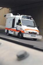 Canadian surveying van driving on road 