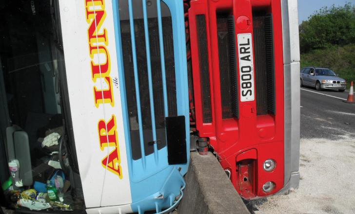 overturned bus on barrier