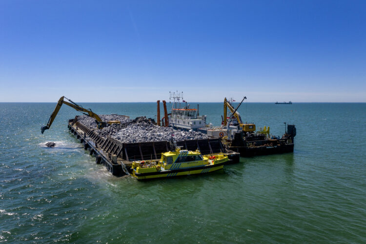 Work continues in June on a breakwater for the harbour in Rødbyhavn where sections of the tunnel will be constructed and floated out for placement (photo copyright Femern/Nils Lund Pedersen)