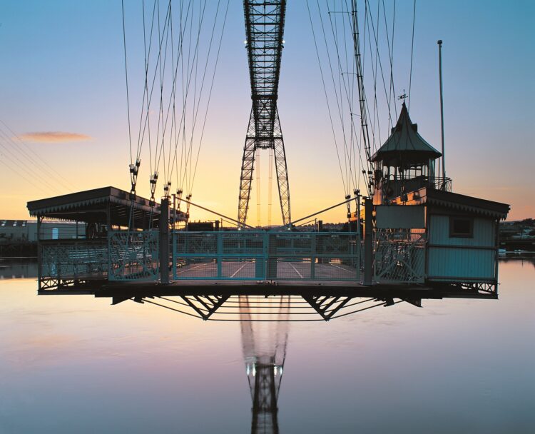 The transporter’s vehicle-carrying gondola hangs suspended from the upper structure, close to the River USk’s high-tide mark