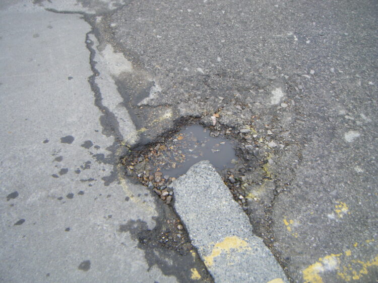 The UK’s pothole problem continues as insufficient funds are available for effective maintenance – image © courtesy of Mike Woof