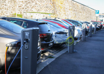 Electric cars plugged and charging at a car park in Oslo, Norway © Gvictoria | Dreamstime.com