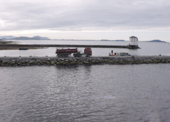 Excavated rock is being hauled from the tunnel excavations for the causeway construction operation