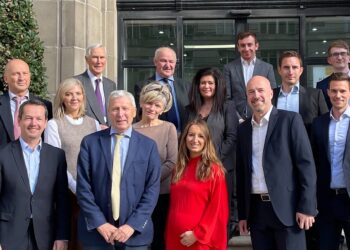 Swarco COO Michael Schuch (front row, left), Geoff Lloyd (2nd from left) and Harald Mosböck (2nd from right) with further members of the Lloyd family, senior Swarco managers and local solicitors - image courtesy of Swarco