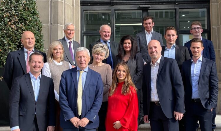 Swarco COO Michael Schuch (front row, left), Geoff Lloyd (2nd from left) and Harald Mosböck (2nd from right) with further members of the Lloyd family, senior Swarco managers and local solicitors - image courtesy of Swarco