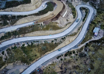 uilding the road has presented challenges to the construction crew and equipment alike