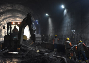A backhoe loader has been used to prepare the tunnel bed for paving - image courtesy of ANI