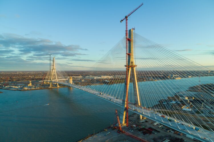 Throughout construction of the CAN$6.4 billion bridge, the two tower cranes lifted heavy materials such as rebar, formwork, anchor boxes and all 216 stay cables (image courtesy of WDBA)