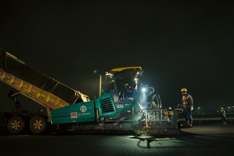 The large hoppers in the pavers were important for ensuring a continuous flow of material to the screed