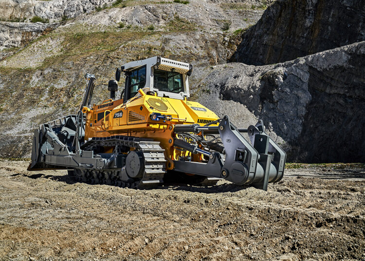 The Liebherr PR 756 crawler dozer in action with the ripper attachment, efficiently breaking and loosening material in a quarry environment.