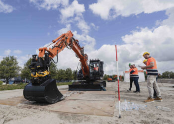 One of the tasks involved flipping bottles up from the ground (Image: Hitachi Construction Machinery Europe/HCME)